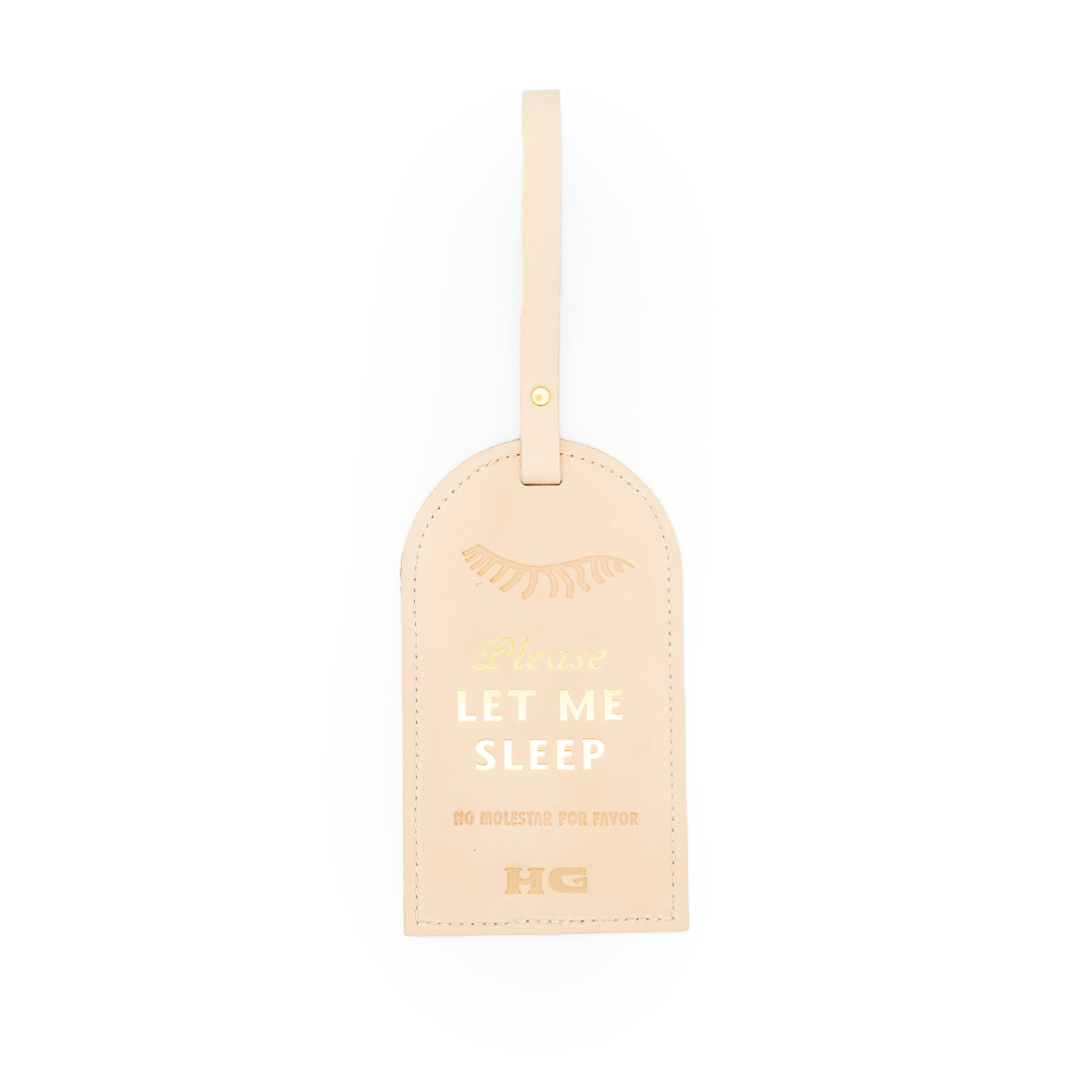 Tan leather door hanger with 'Please Let Me Sleep' text and eyelash illustration