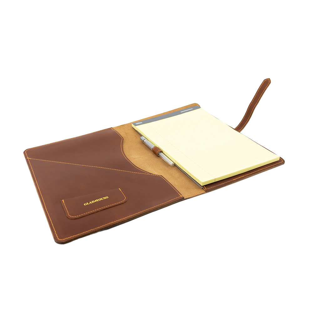 Open brown leather portfolio with a yellow notepad and pen inside