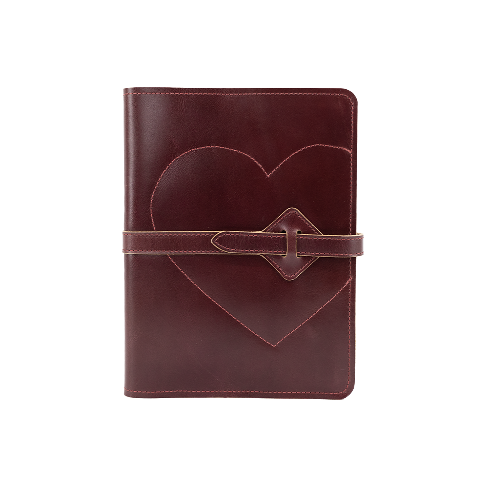 Red leather notebook with a heart design and strap closure