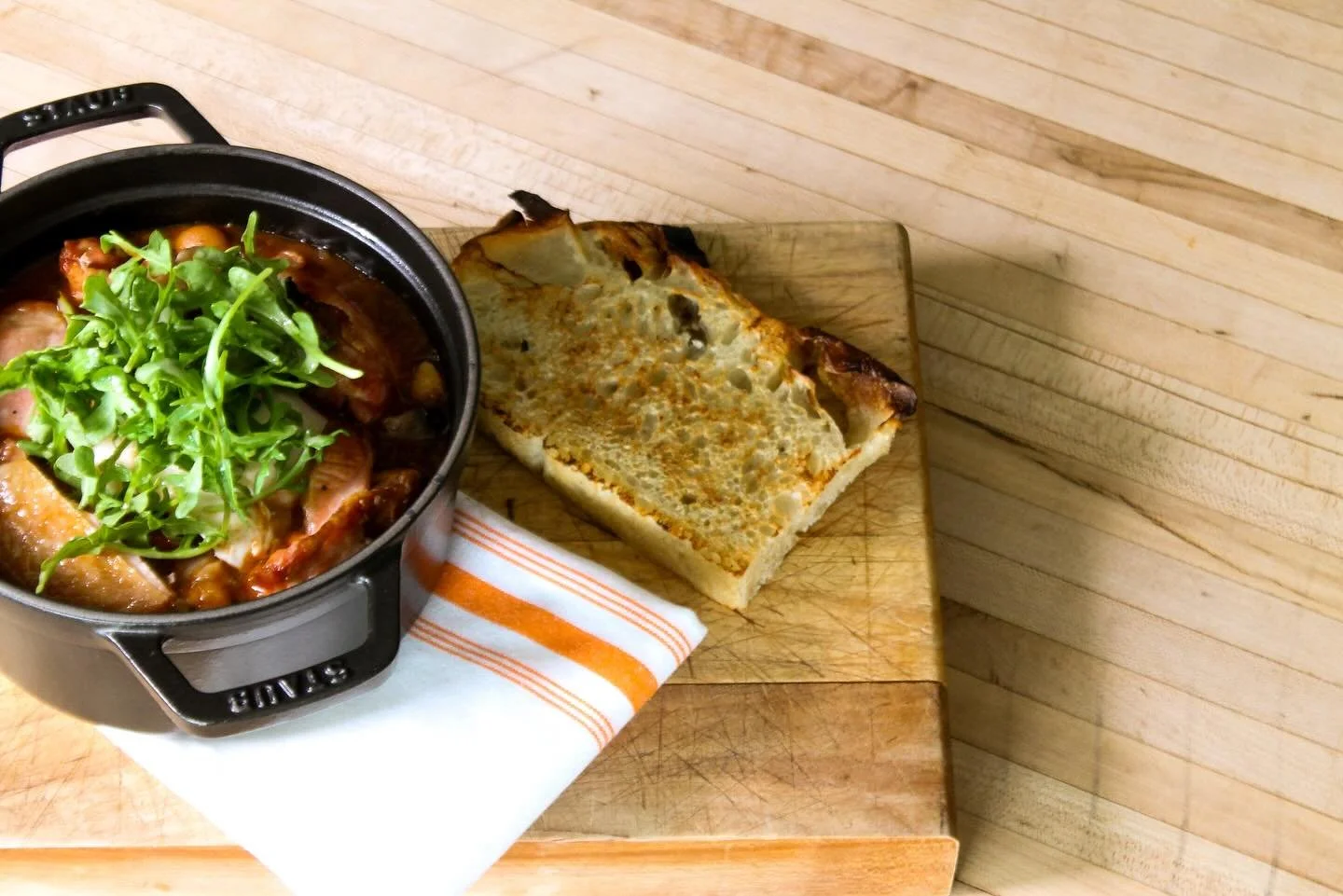 This is our cassoulet.  @chef_tony_tipping used to make  very fancy version of this at Privada Wine and Tapas but it was wrapped in caul fat, kinda like a little sausage.  It was delicious and a lot of work. 

Now we top it with poached eggs and arug