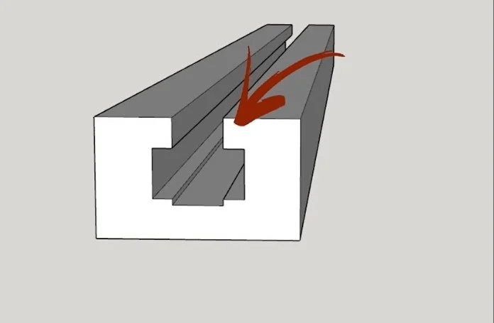 a digital rendering of the edge of a piece of t track, with an arrow pointing at the lip