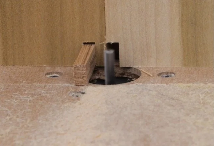 first wooden workpiece put over the indexing pin with the second piece butted up to the first piece, and then a cut made on the diy router