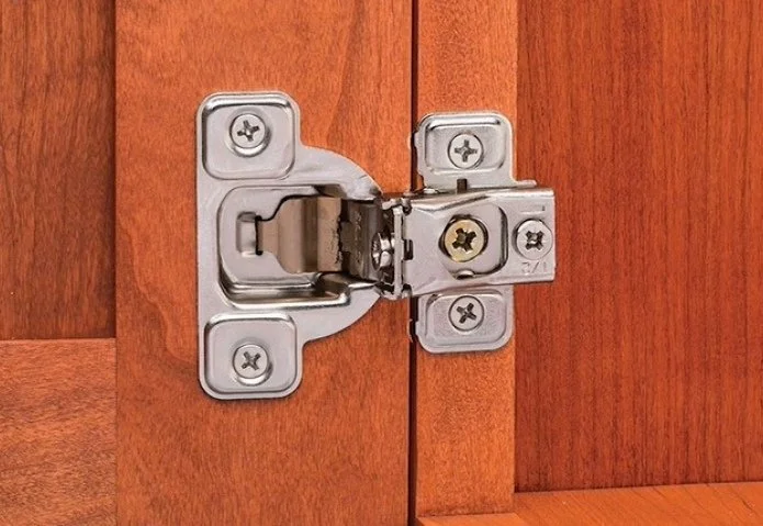 door hinge with attached door mounted to a face frame