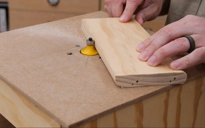 cutting a board on the diy router table with a bearing guided router bit