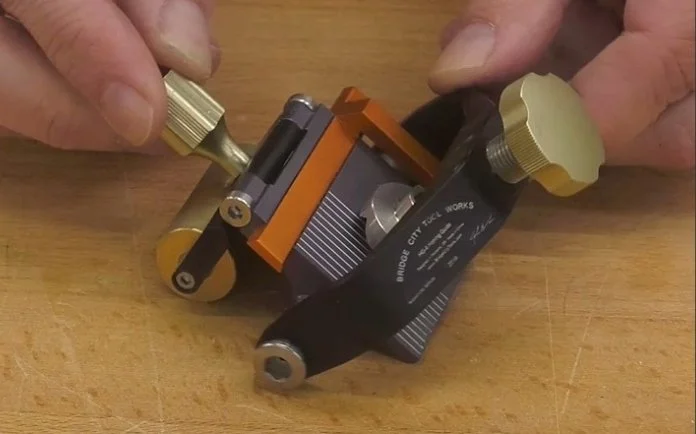 bridge city honing guide on a wooden workbench top
