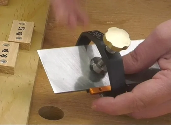 a chisel blade in a sharpening jig