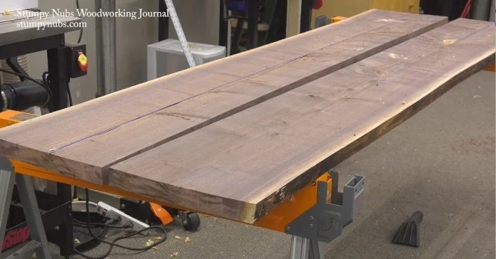 2 slabs of wood side by side on top of saw horses