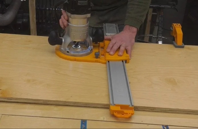 cutting a dado using a handheld router and edge guide