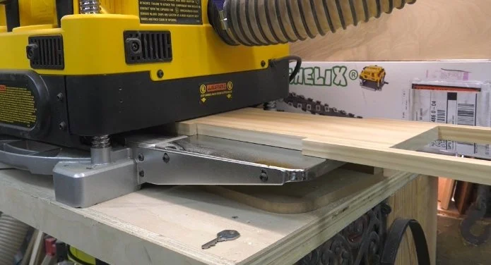 scrap pieces of wood attached to each corner of a piece of wood as it goes through a thickness planer to prevent snipe on each end