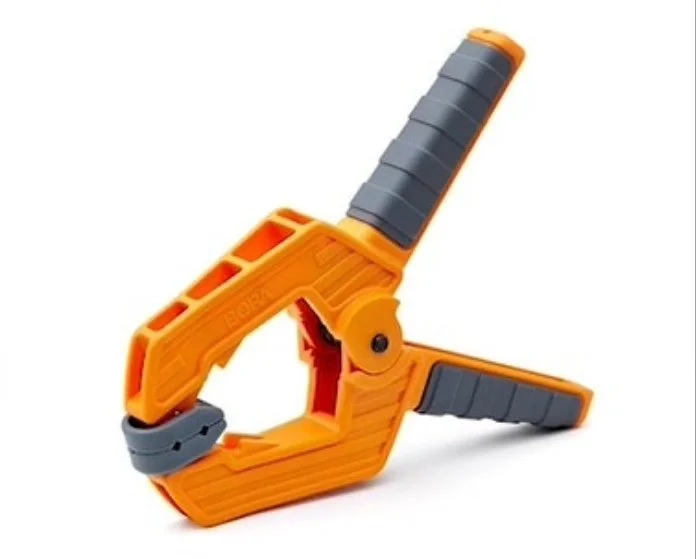 a orange and grey spring clamp on a white background