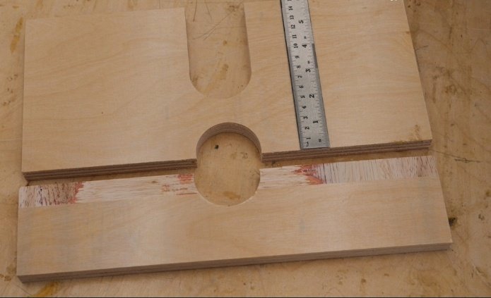two pieces of wood with semi cut holes in them to make up a router fence