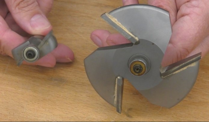 a pair of hands holding a large router bit vs a small router bit