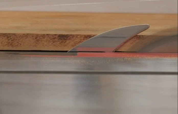 scorch marks on the side of a board being cut on a table saw