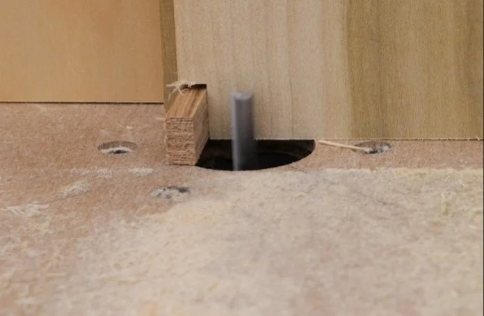 making a cut on the router table through both workpieces, offset