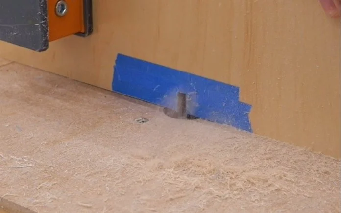 cutting a kerf in a piece of plywood on a diy router table