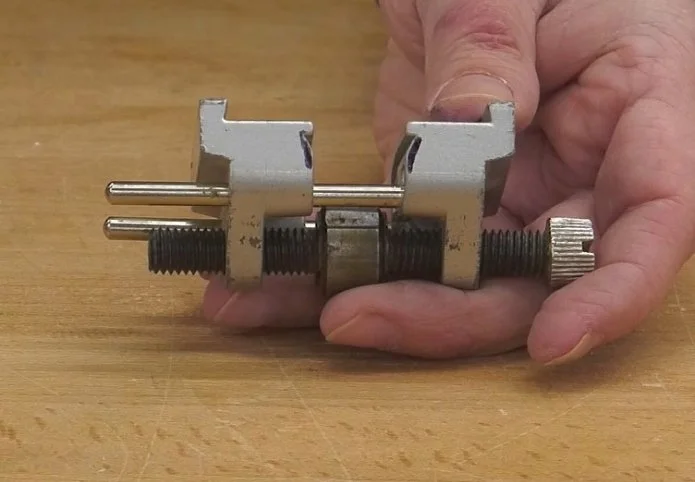 black pen marks along the edges of the jig's notches to indicate where to file