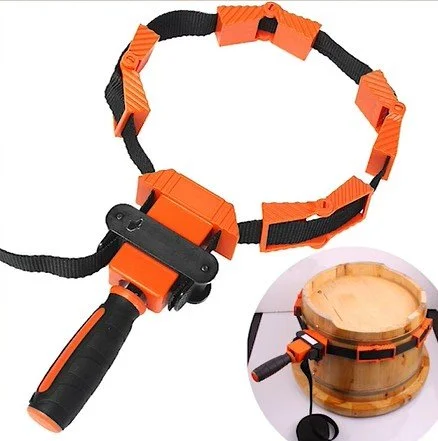 an orange and black band clamp on a white background, with a picture of the band clamp in use around a cylindrical object in the bottom right corner