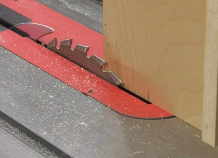 a saw blade right up against the carriage of the incremental tenon jig
