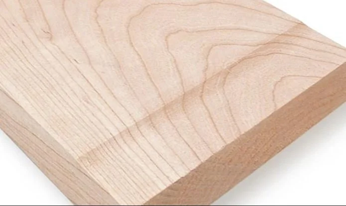 a wood board with planer snipe on the end over a white background