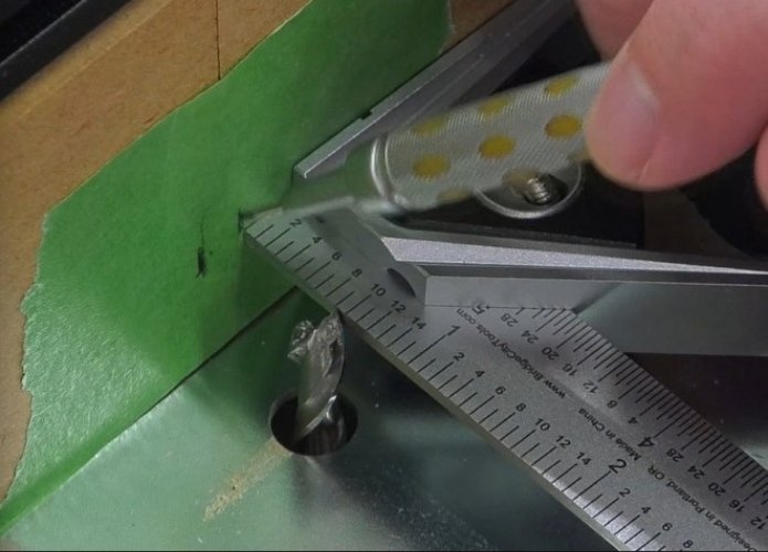 marking the edges of a router bit on the fence using a piece of green tape, a pencil, and a square