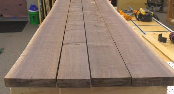 a slab of wood cut into four pieces, looking from one end down the length of the boards