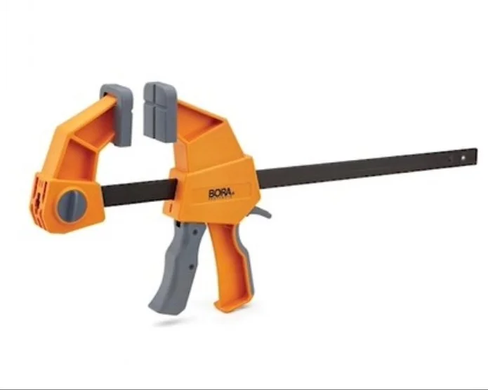 a grey and orange pistol grip clamp on a white background