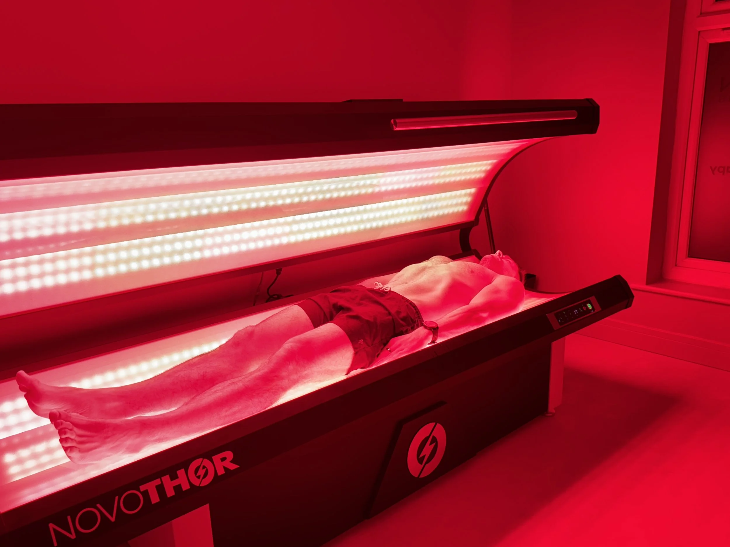 Full-body red light therapy session using the NovoTHOR XL bed at ReGen Rooms