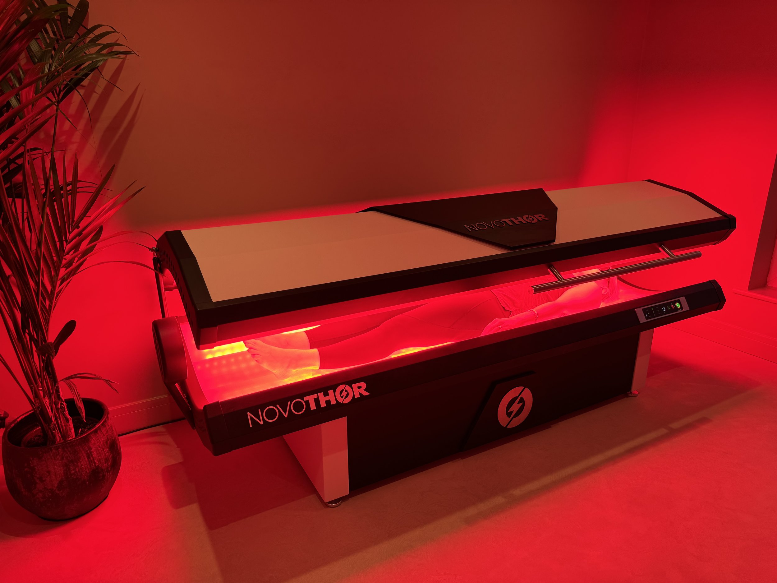 NovoTHOR red light therapy bed inside private recovery room at ReGen Rooms