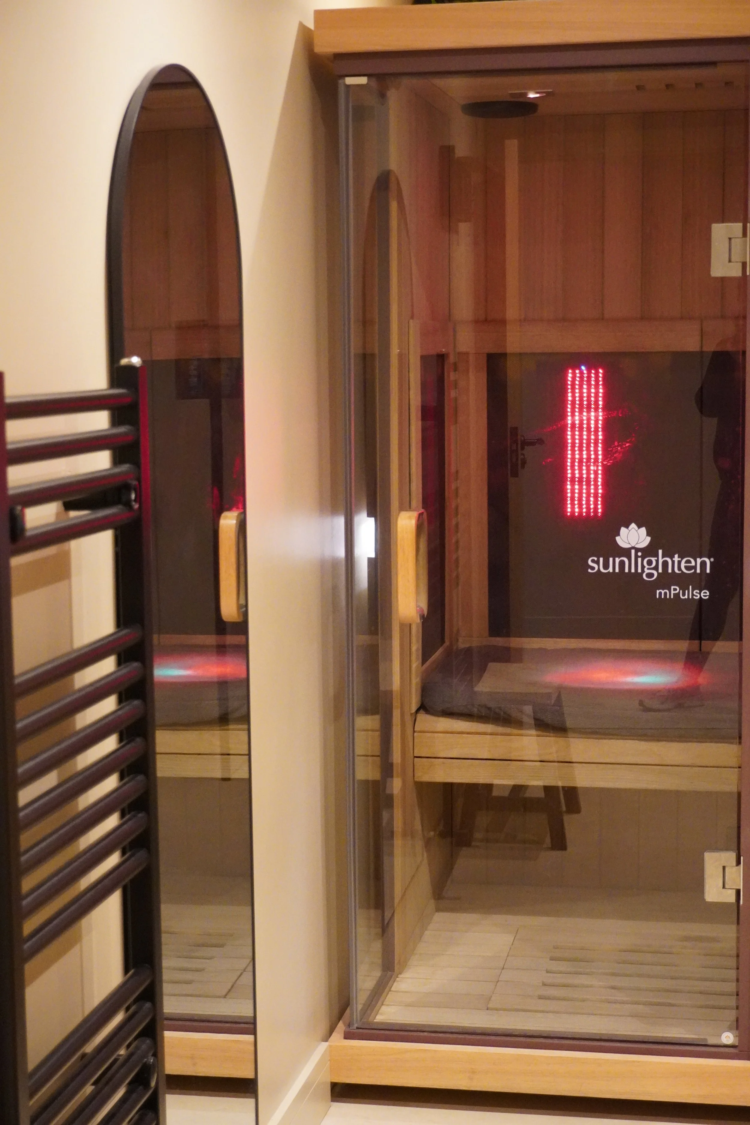 Infrared sauna interior with red light panels used for heat-based recovery at ReGen Rooms