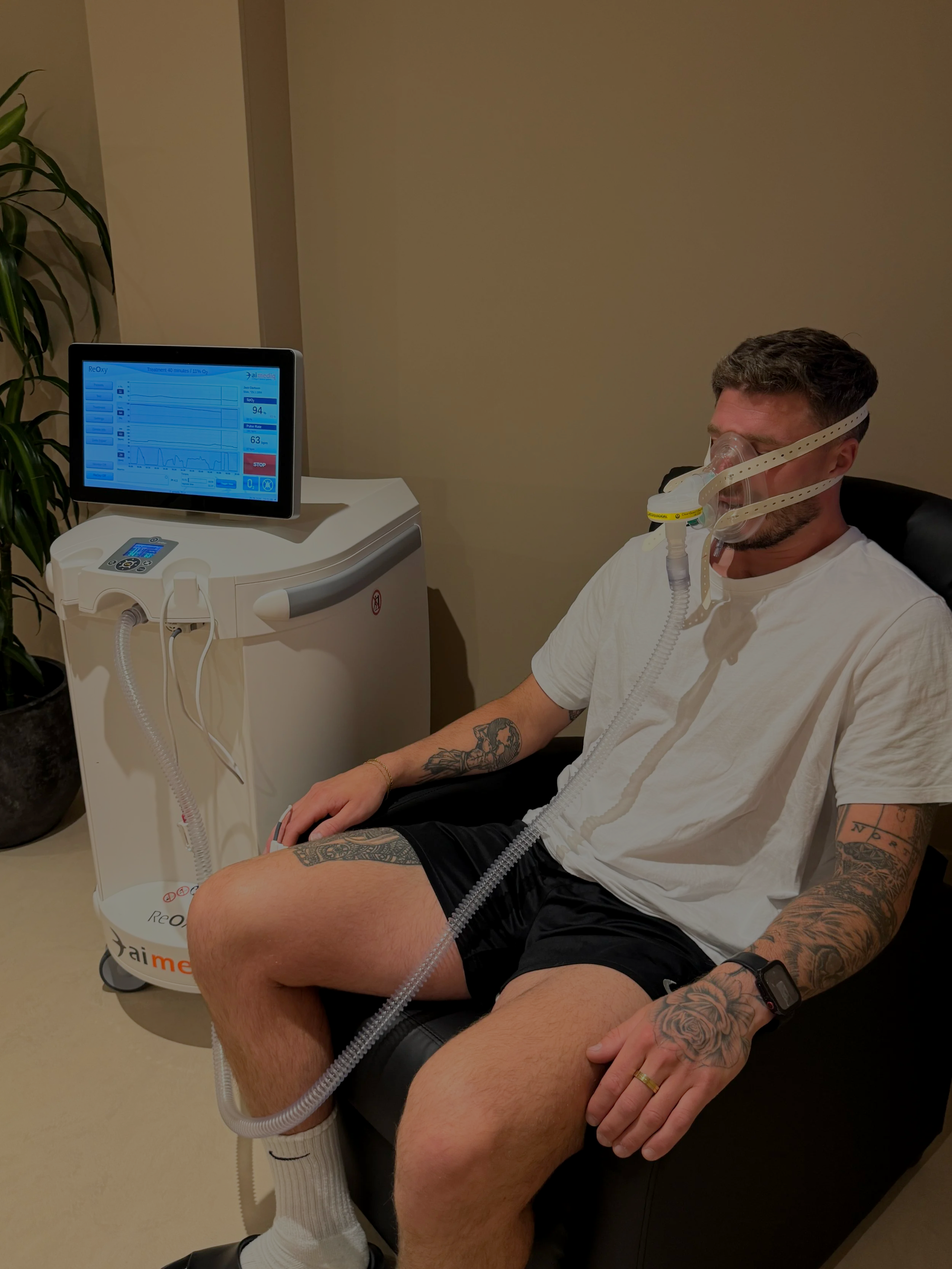 Man undergoing Intermittent Hypoxic-Hyperoxic Training (IHHT) oxygen therapy at ReGen Rooms wellness clinic.