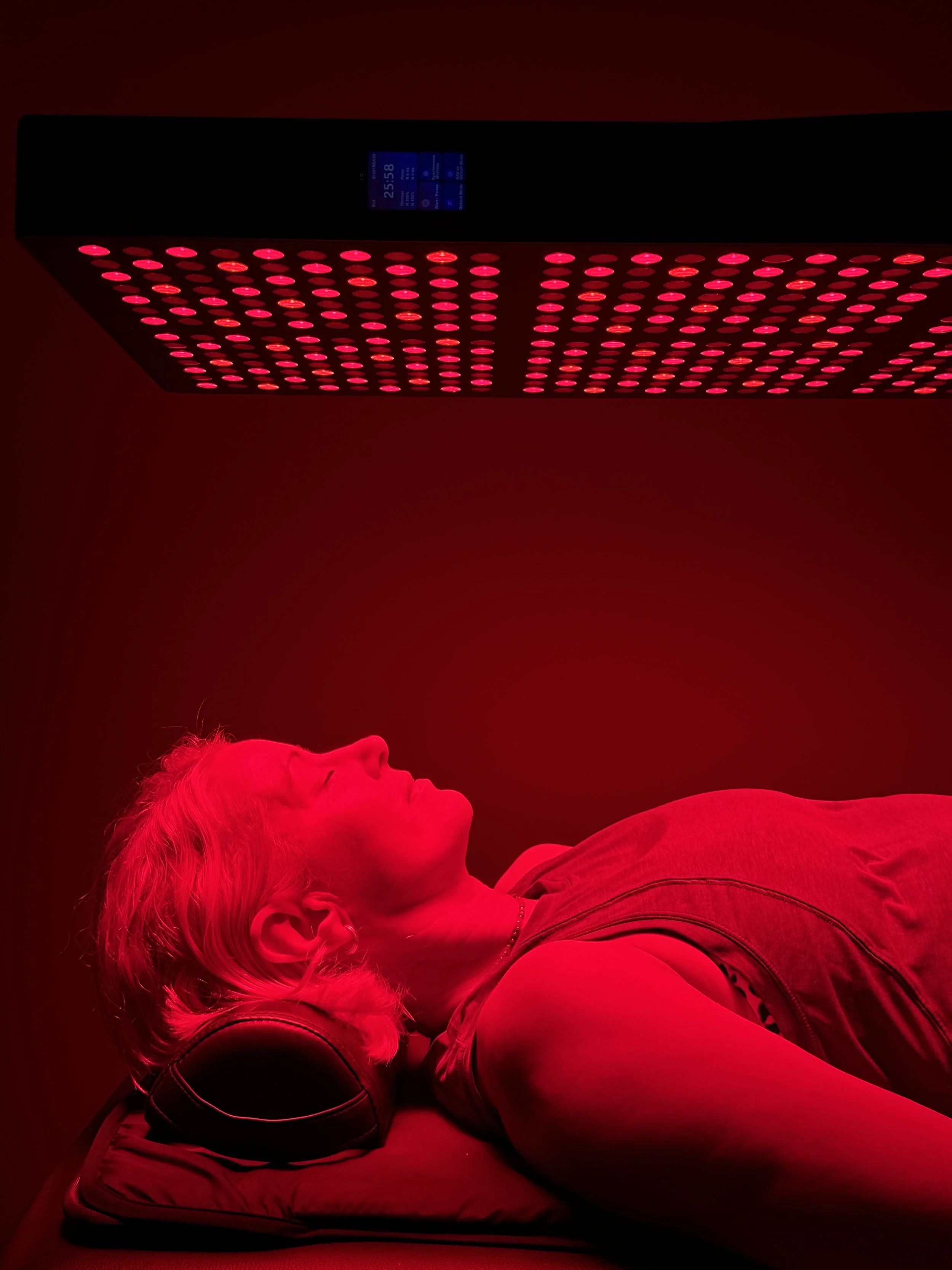 Client receiving full-body red light therapy to support skin tone, circulation and cellular repair