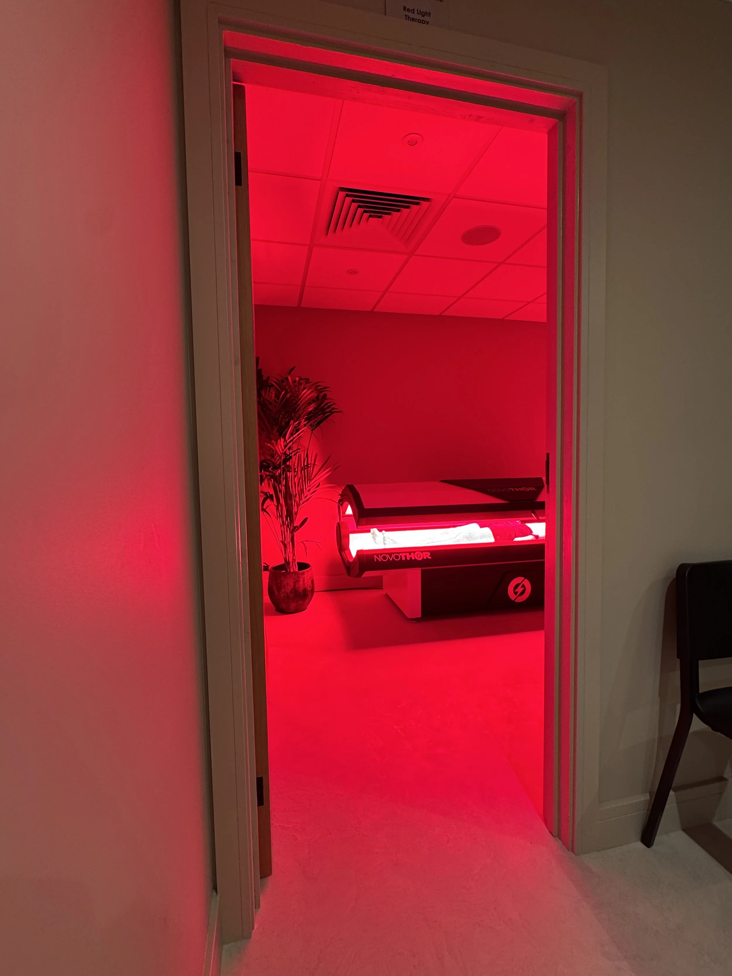 NovoTHOR full-body red light therapy bed at ReGen Rooms used for skin health and cellular recovery