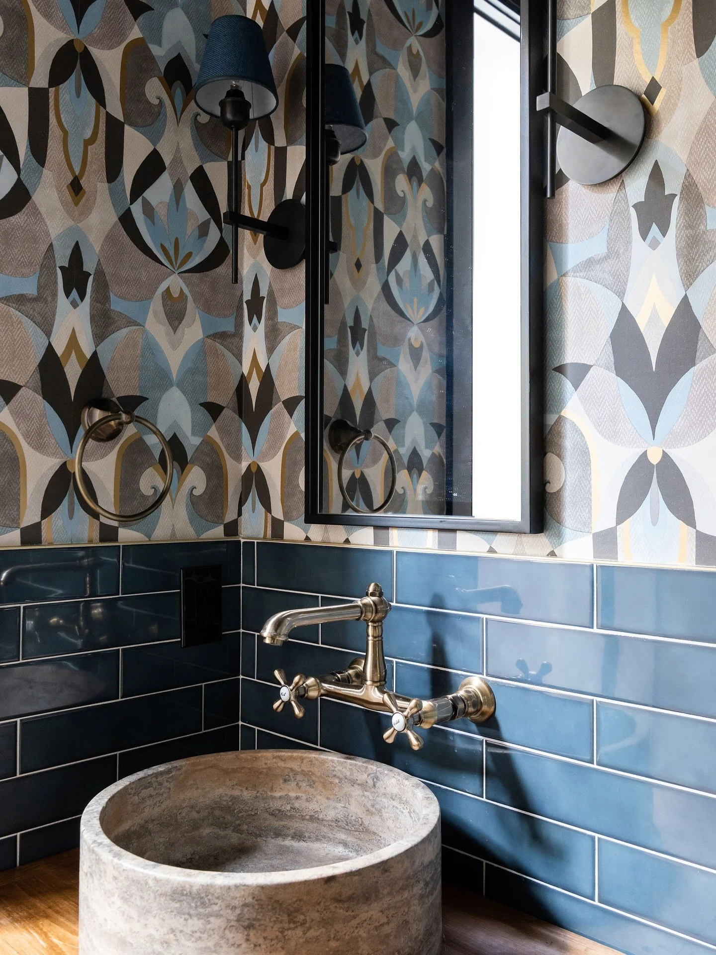 Bold. Layered. Unapologetically custom.
This powder bath isn&rsquo;t just a room, it&rsquo;s a conversation starter.

We paired rich navy tile with a moody patterned wallpaper to create contrast and depth, anchored by a reclaimed vanity and a hand-ca
