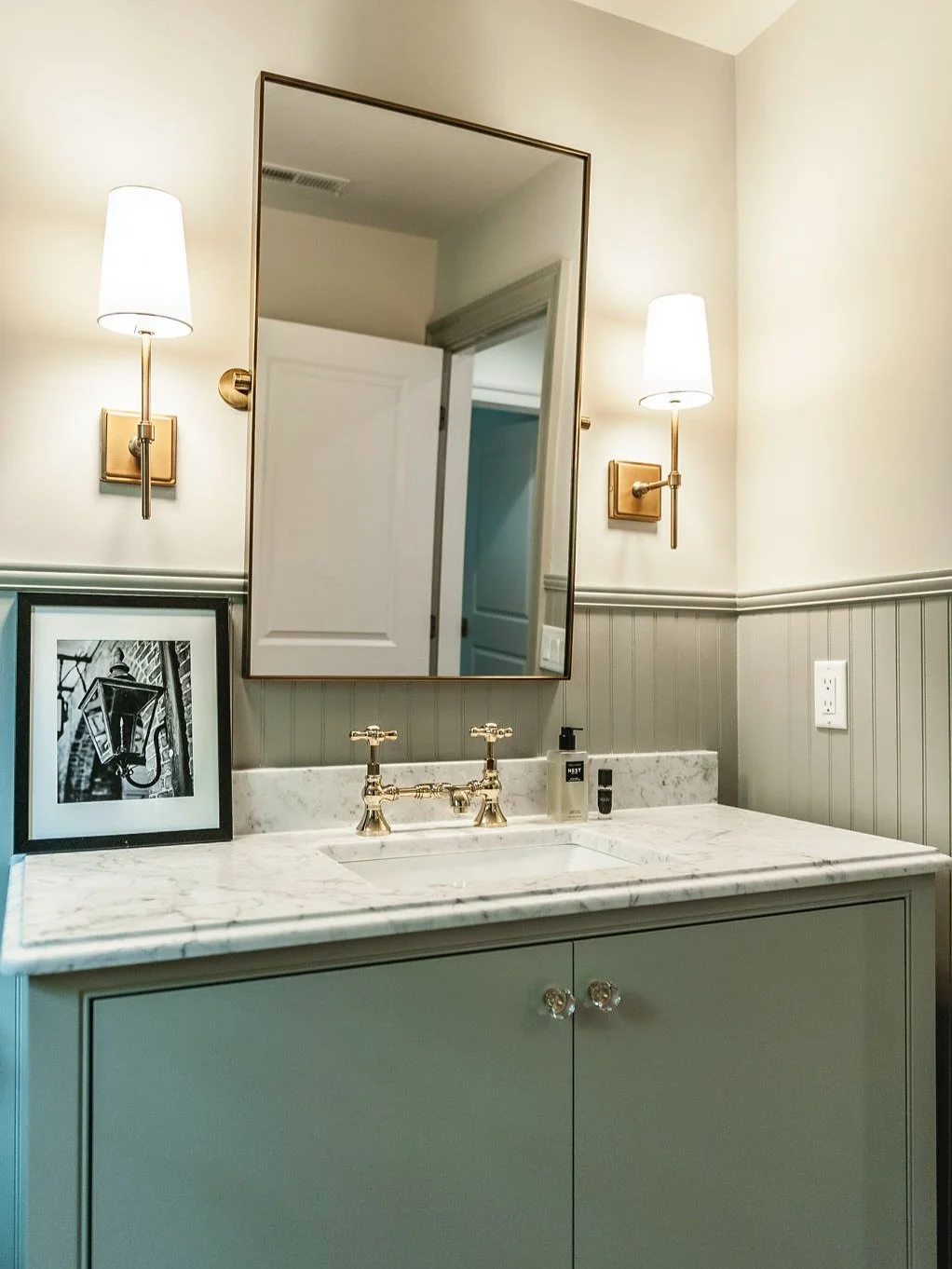 This powder bath blends timeless character with modern luxury, marble countertop, brass fixtures, and classic beadboard wainscoting. It&rsquo;s proof that small spaces can carry just as much charm and craftsmanship as the heart of the home.

Would yo