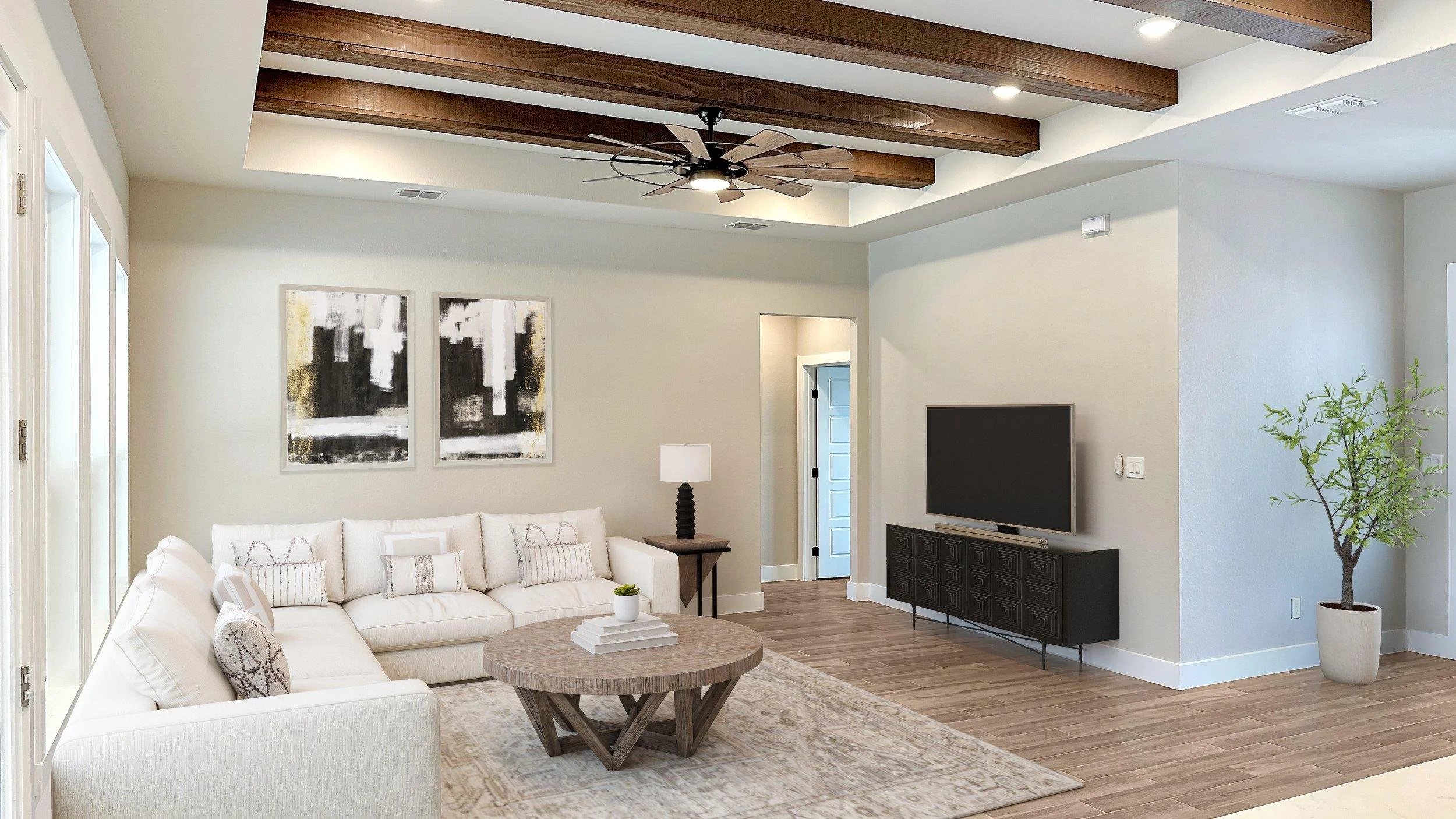 High-Performance home renovations in San Antonio featuring a living room with wood-wrapped beams, wood flooring, and a TV area.