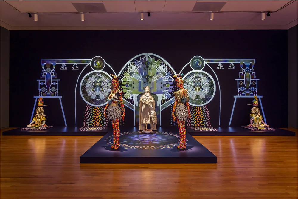 An art installation including humanoid figures made of paper and other mixed materials