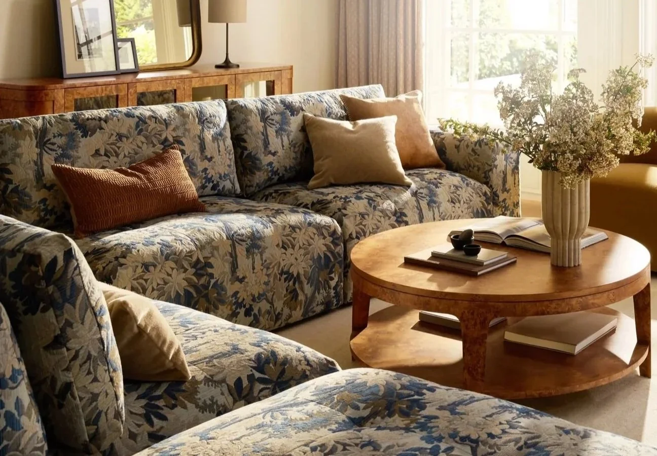 floral patterned sofa and burlwood tables