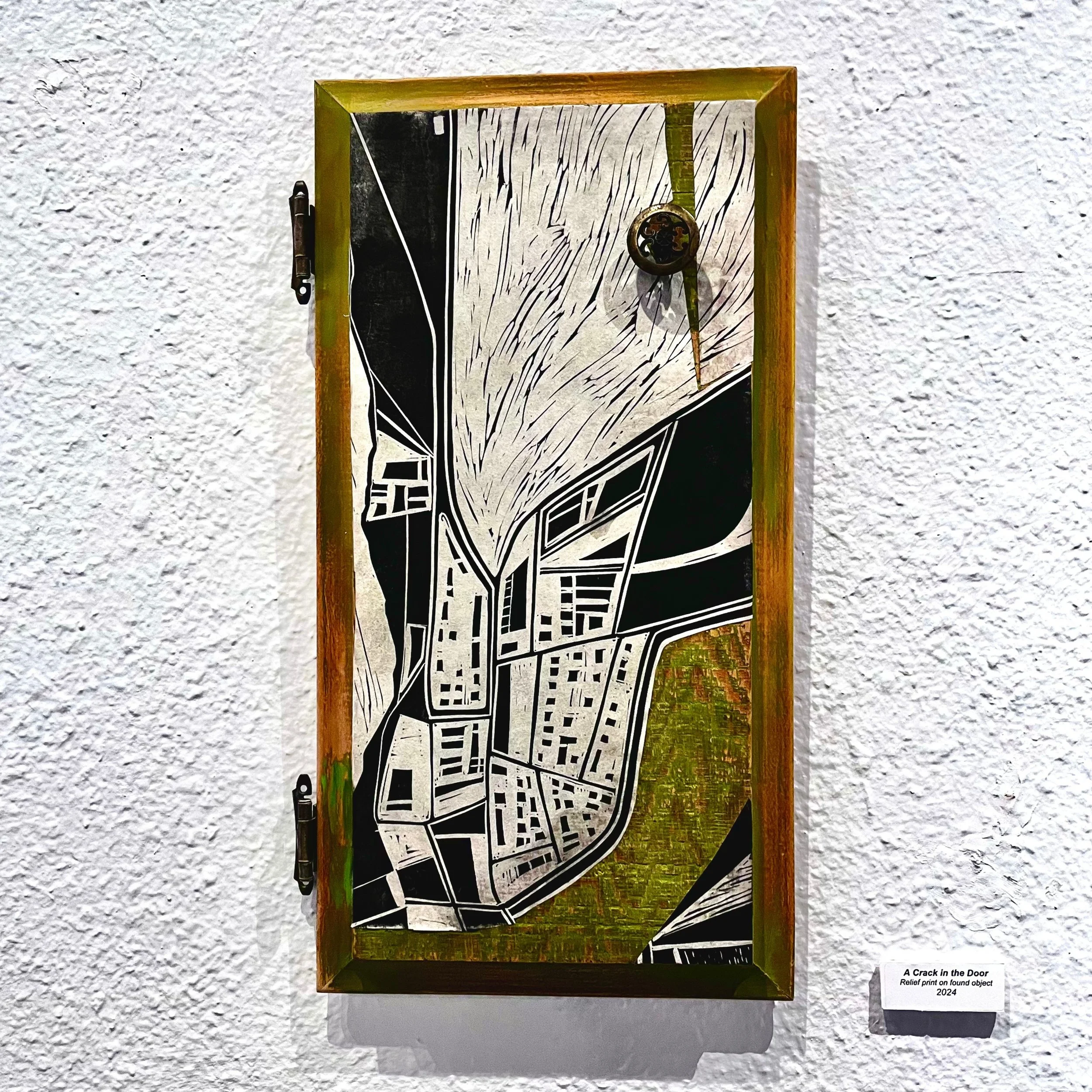 A Crack in the Door, Relief print on found object, 6.5” x 14”, 2024