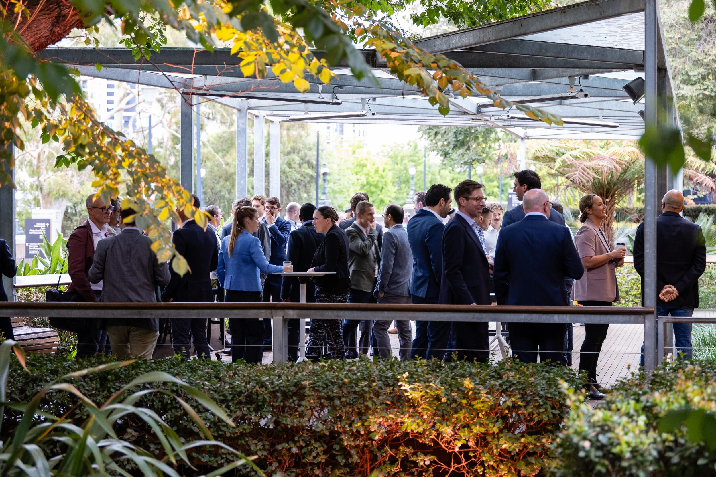 Conference delegates networking during arrival drinks at Property Council of Victroria outlook lunch. The outdoor deck at Zinc at Fed Square is the ideal space for networking drinks, coffee breaks and activations. 