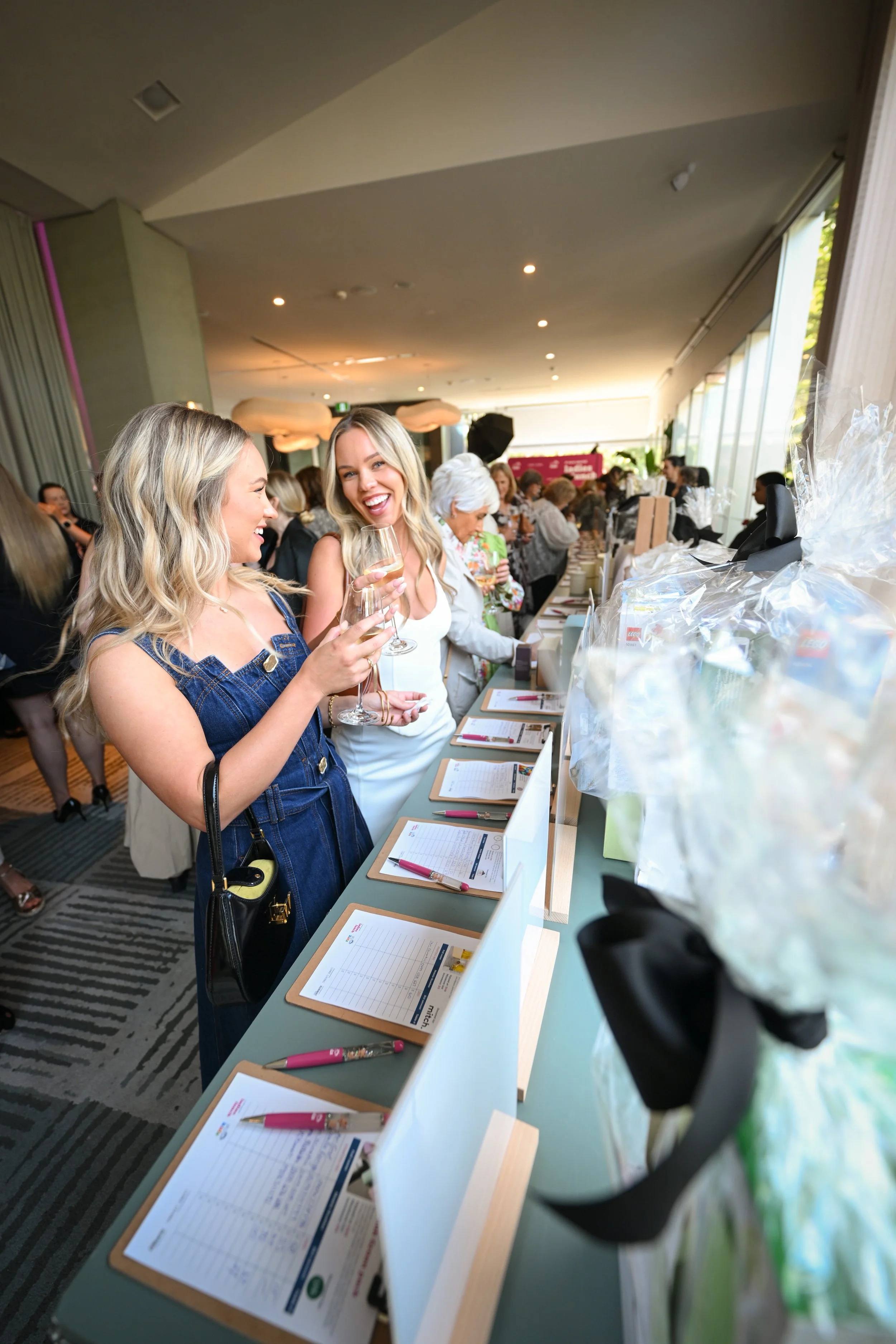 Photo of charity fundraiser event sleek modern table scape with flowers and candles