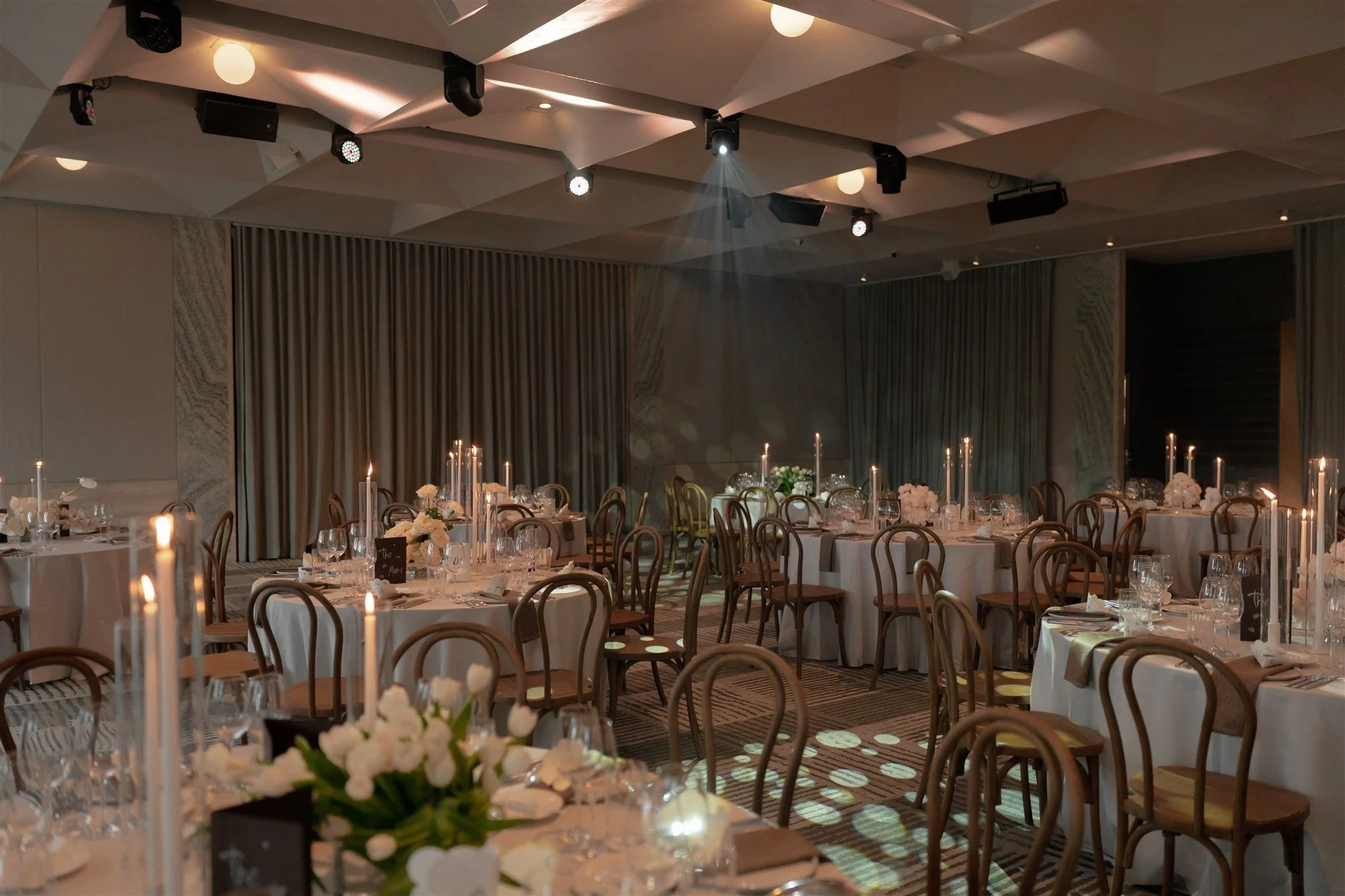Round guest tables set for 10. Traditional wedding floorplan in a muted, neutral tones.
