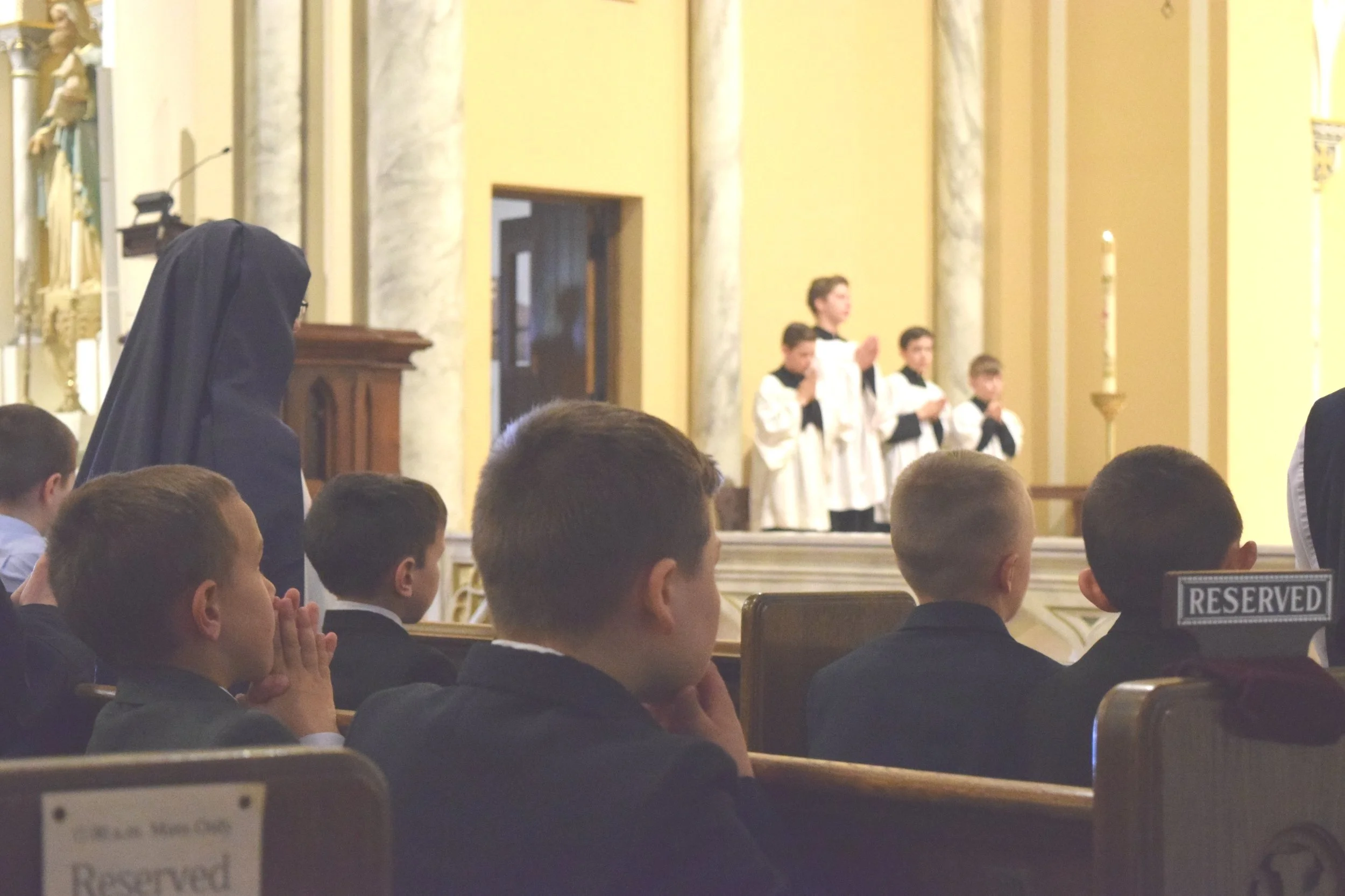 Boys praying at Catholic church in Minneapolis MN
