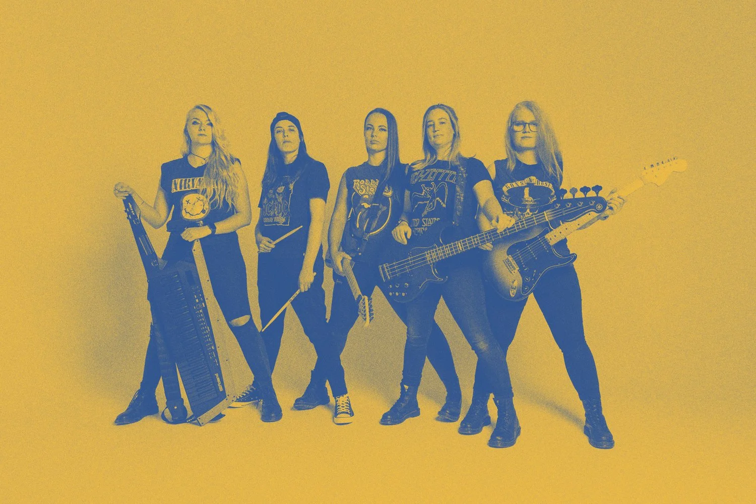 Five women in rock band t-shirts holding musical instruments, posing against a yellow background.