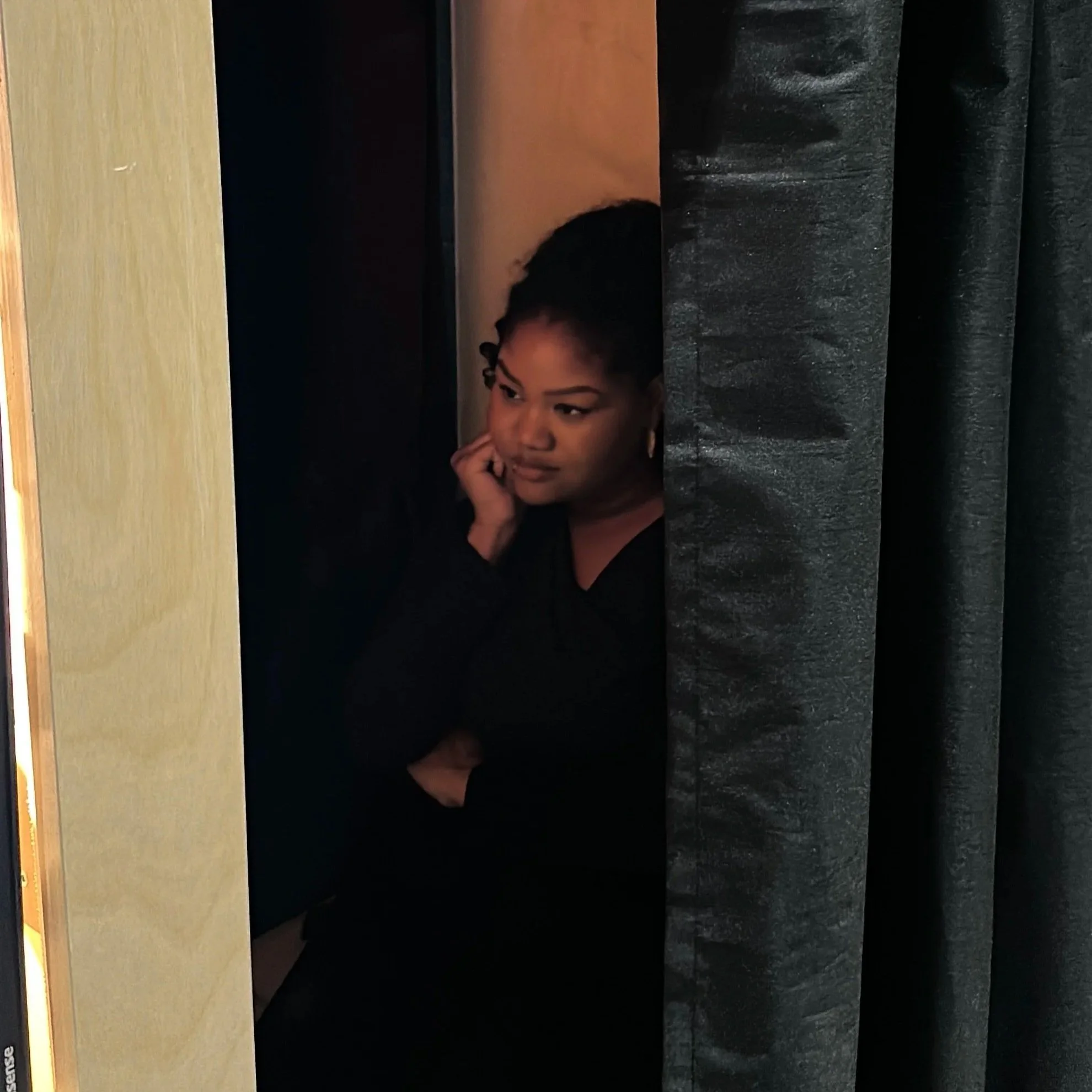 Guest inside enclosed photo booth Toronto — private curtained experience by Revolve Event Services
