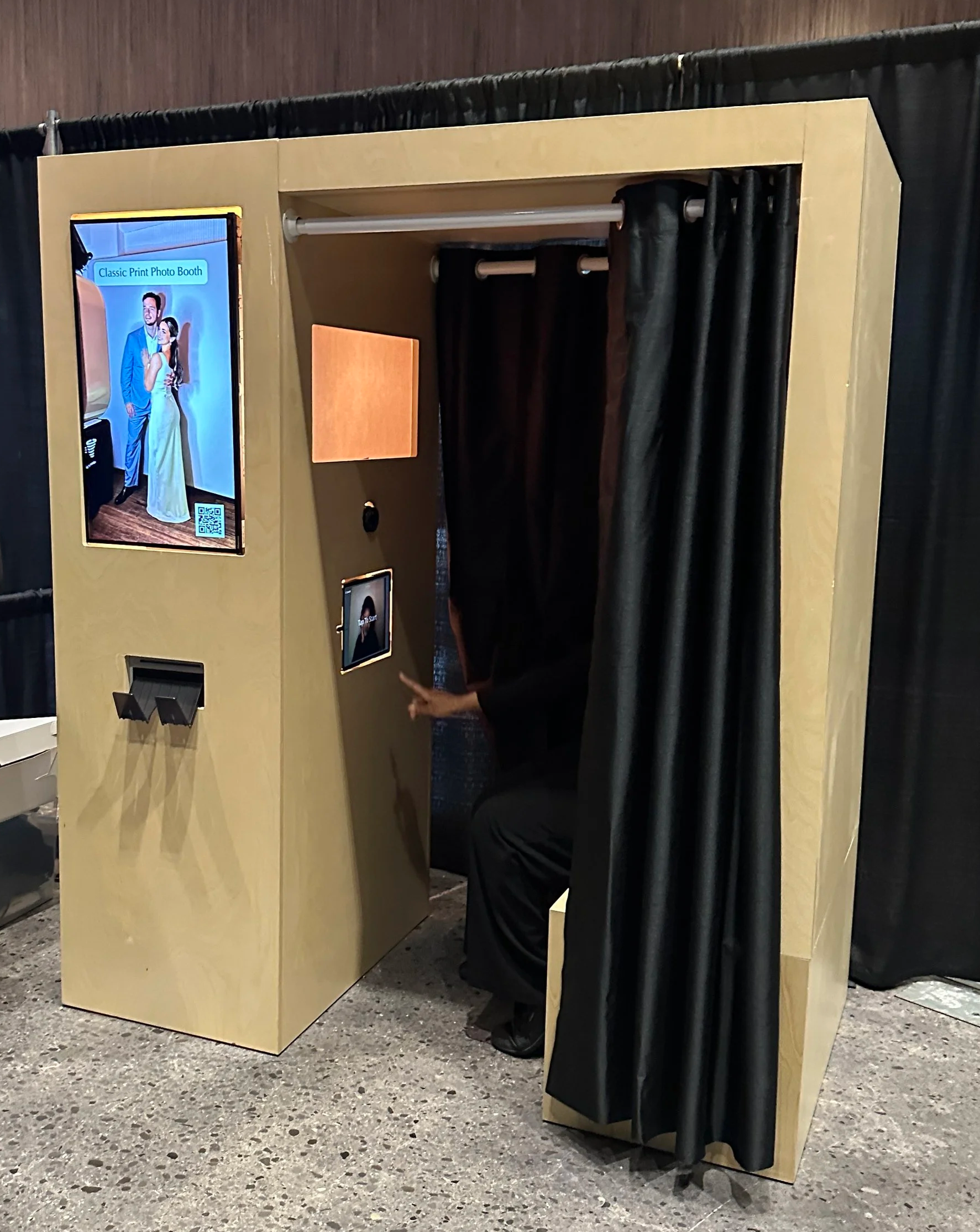 Enclosed photo booth rental Toronto by Revolve Event Services with curtain and instant print slot