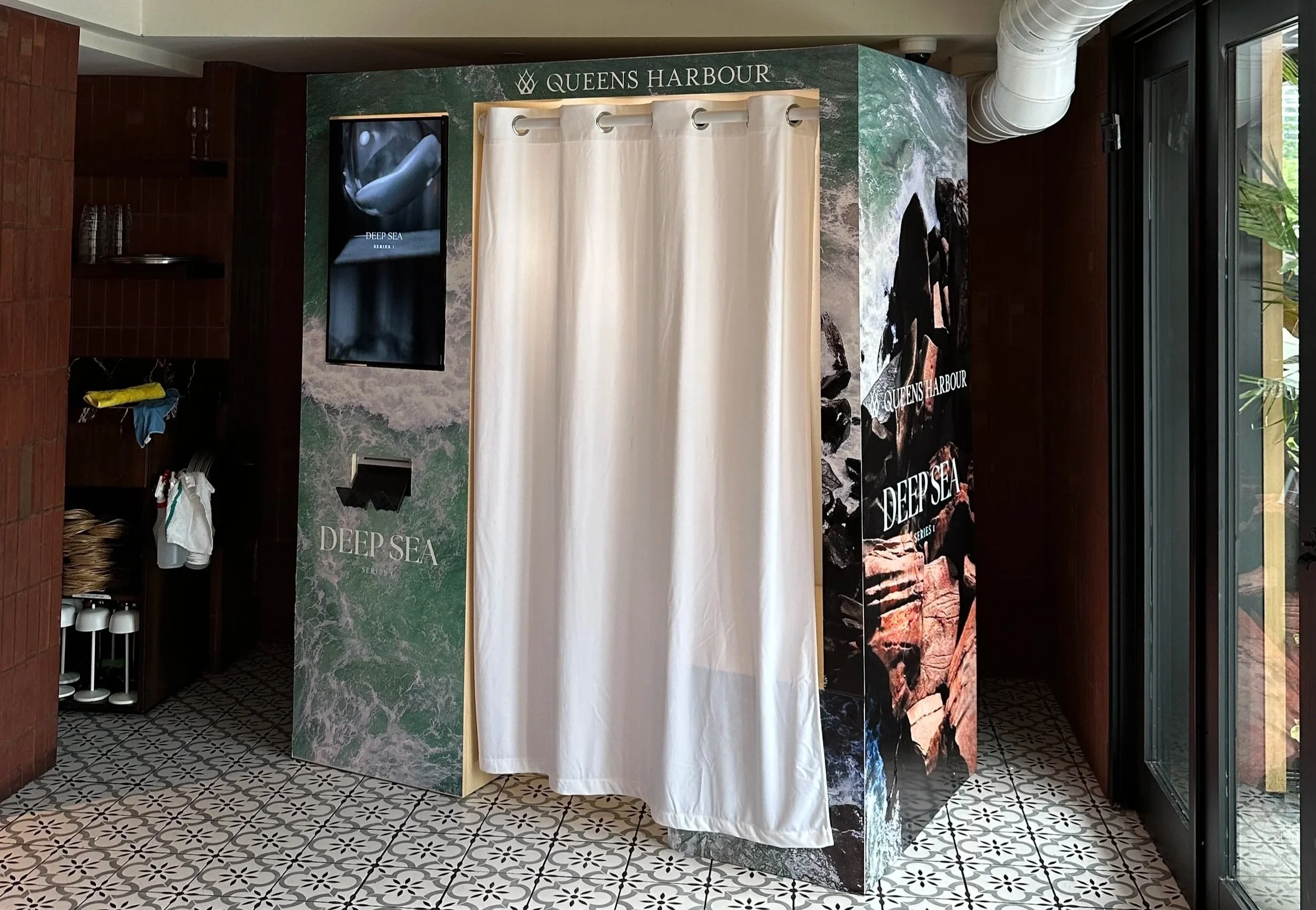 Branded enclosed photo booth activation at Queens Harbour Deep Sea Toronto by Revolve Event Services