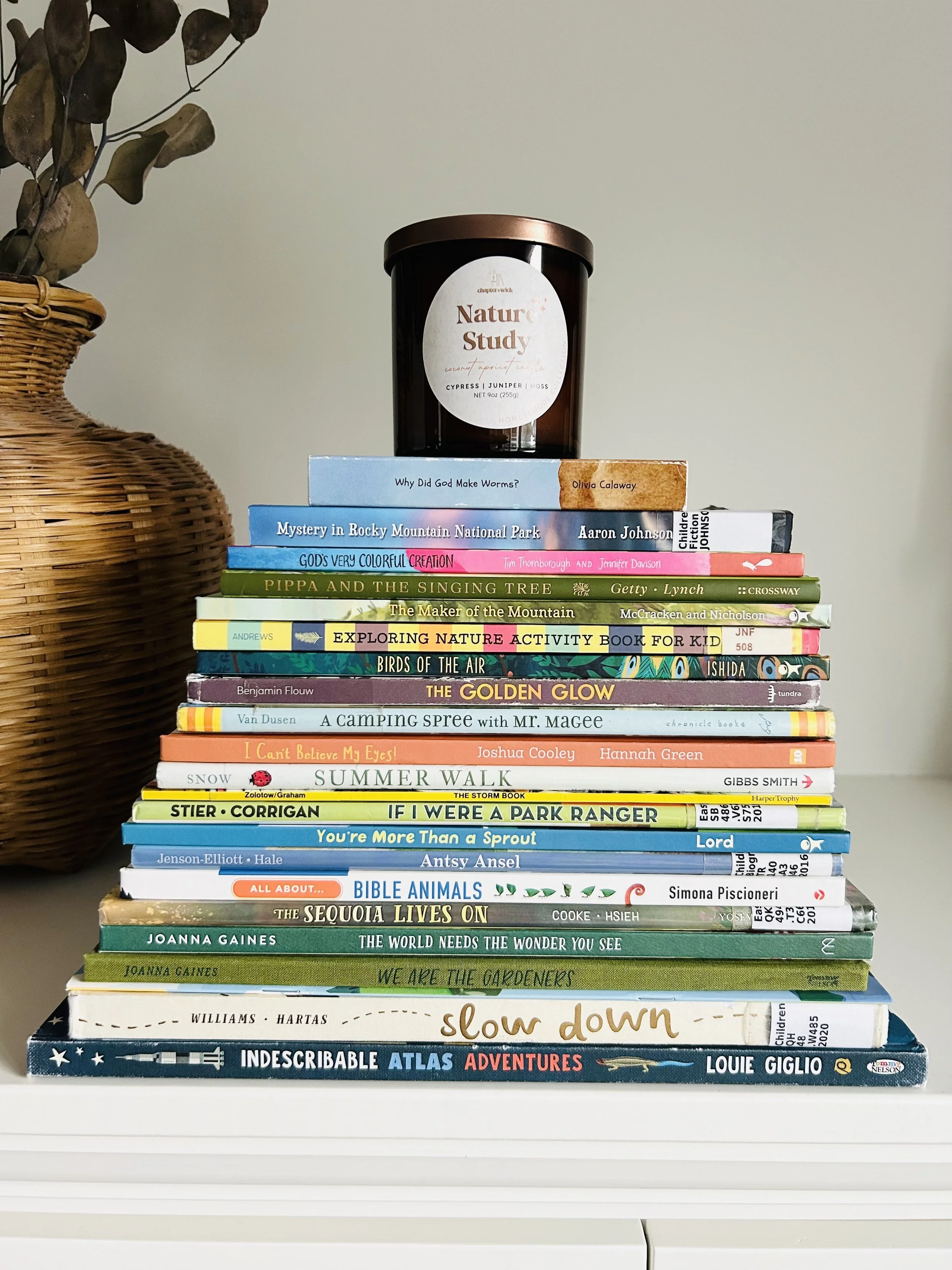 Stack of nature books with a “Nature Study” candle on top