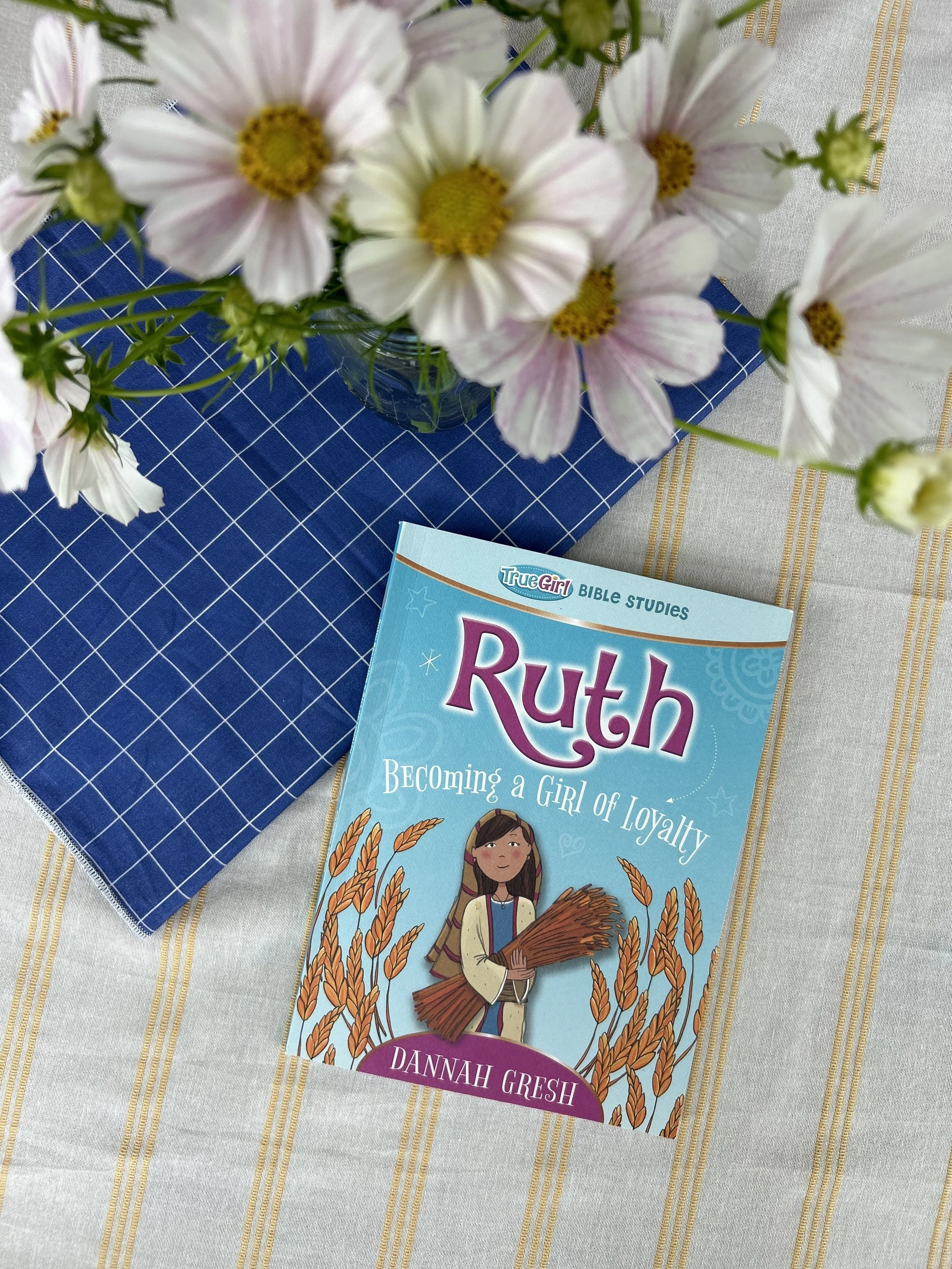 Table view from above with flowers and Ruth: Becoming A Girl of Loyalty bible study workbook
