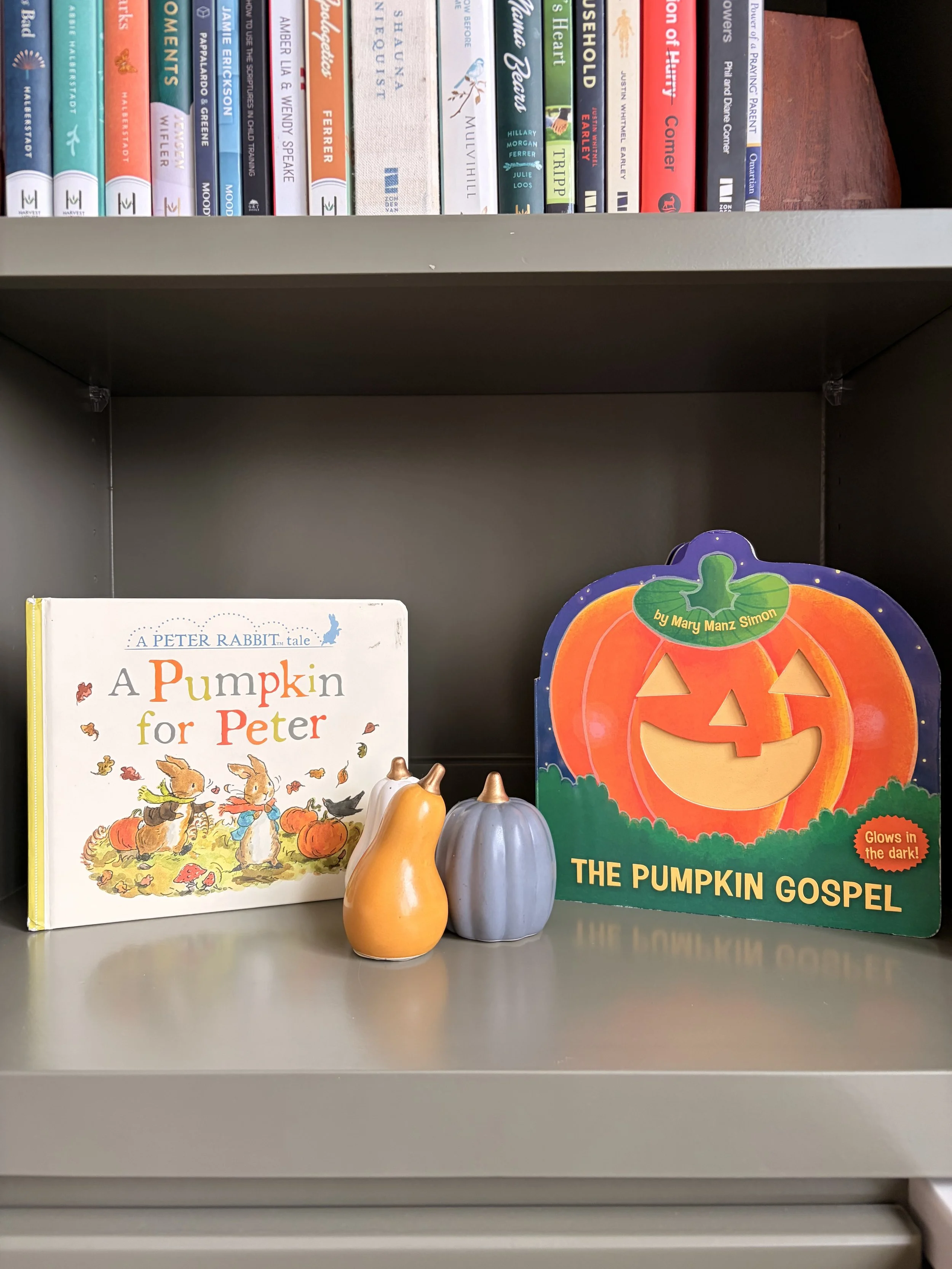 Stack of not-so-scary Halloween books for children with pumpkins