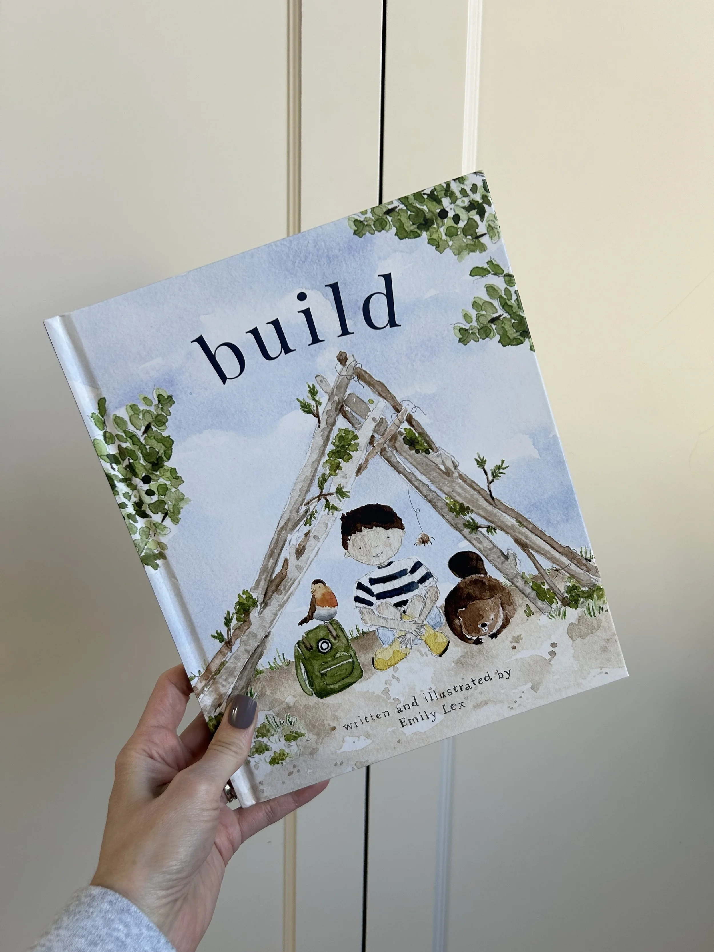 Lexi Thom holding the book Built by Emily Lex, a Christian book encouraging faith and character for boys.